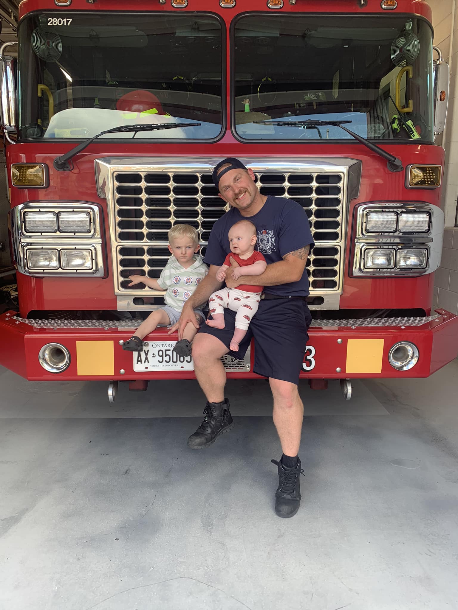 Brendan at the fire hall with his sons Robert and Charlie
