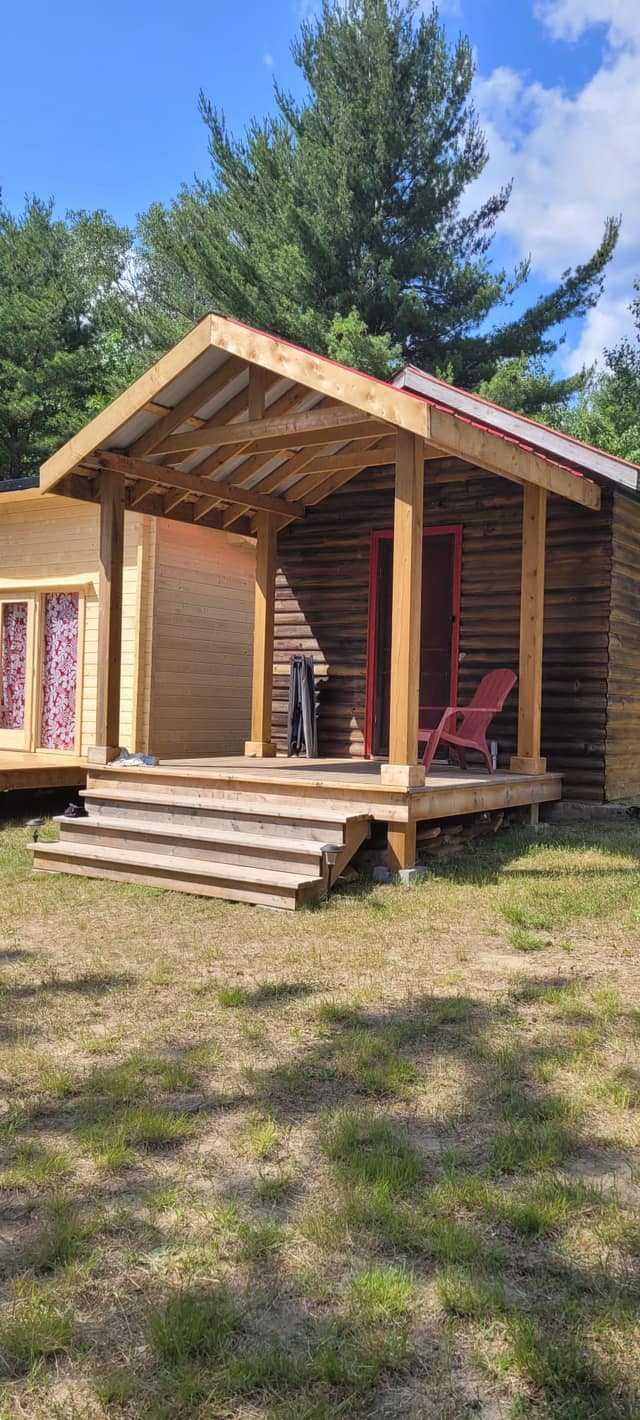 Custom log cabin with covered porch built by R&C Home Renovations